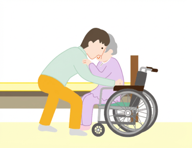 車椅子の方向へ回転させ、ゆっくり腰を下ろします。